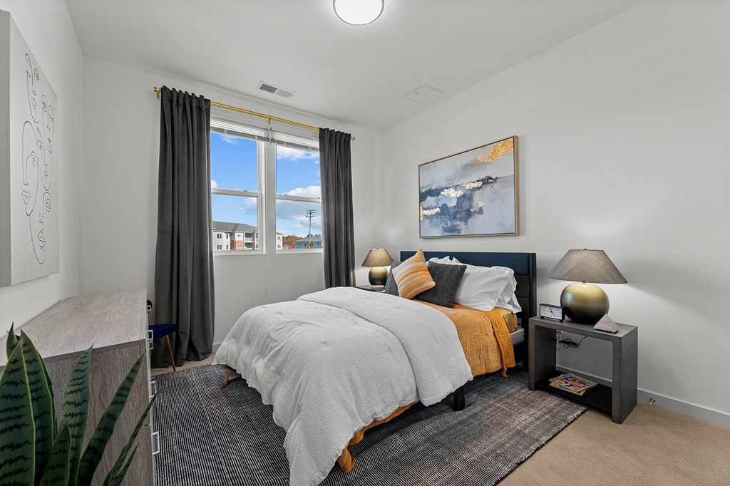 a bedroom with a bed and a window