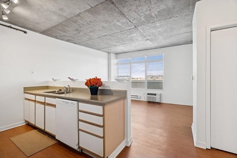 A kitchen with white cabinets and a wooden island.
