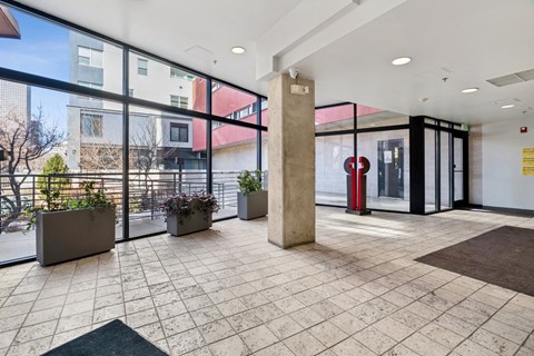 A large open space with a tiled floor and a pillar in the middle.