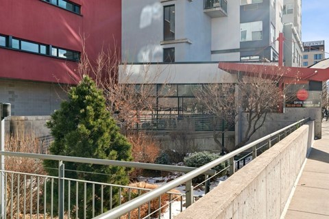 A building with a red and white exterior and a tree in front of it.