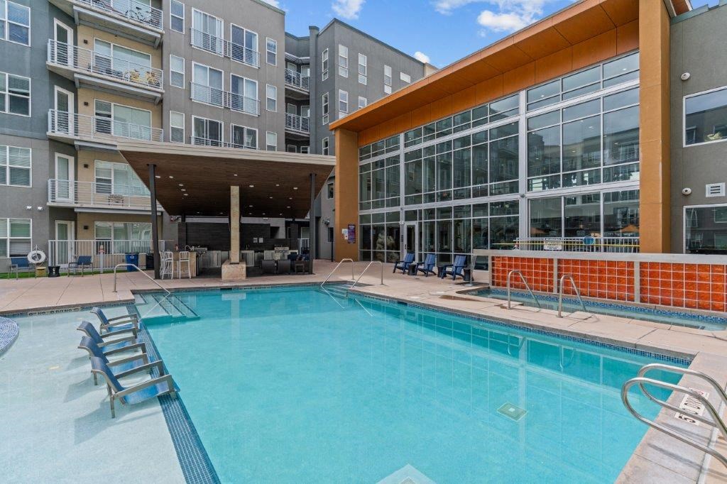 a swimming pool with a large building in the background
