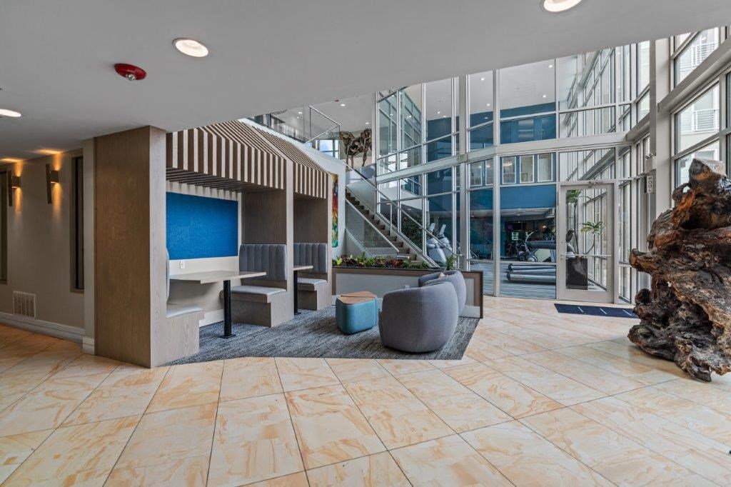 a lobby with a tv and some couches