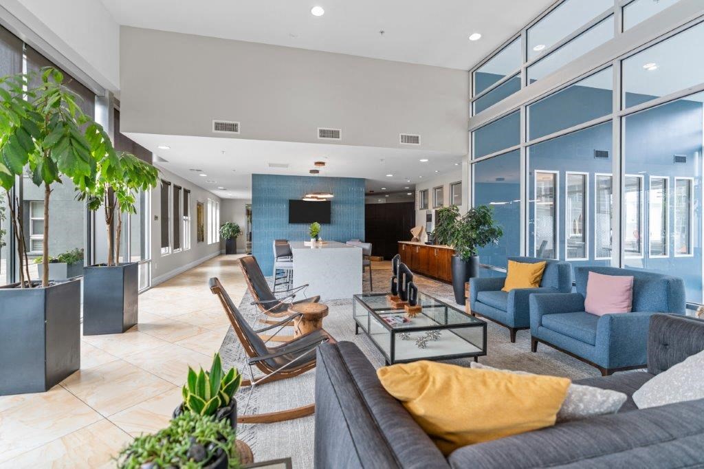 a living room filled with furniture and a large window