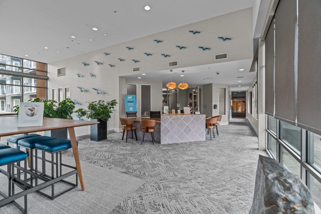 a lobby with a table and chairs and a bar