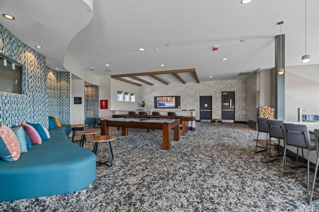 a large room with a pool table and chairs