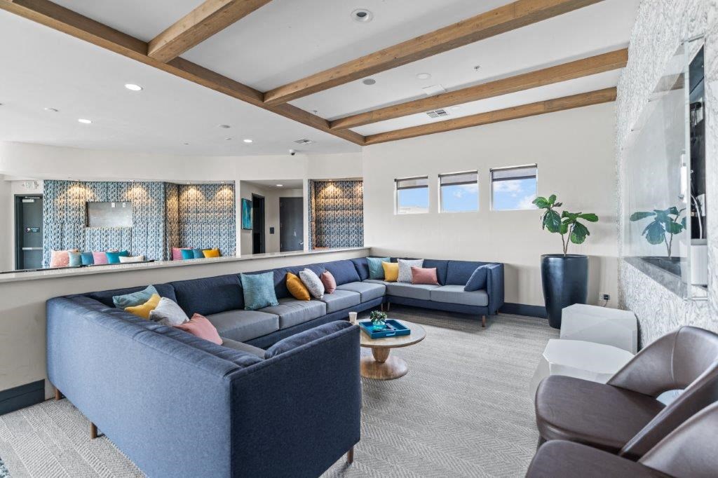 a living room filled with furniture and a large window