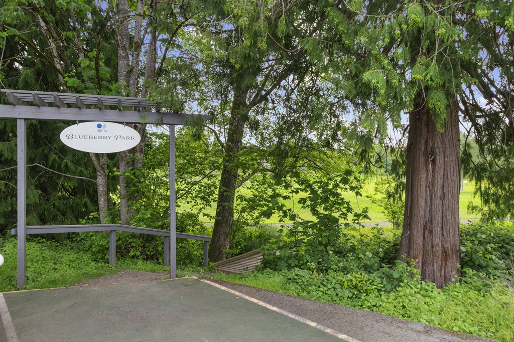 a park with a sign and some trees