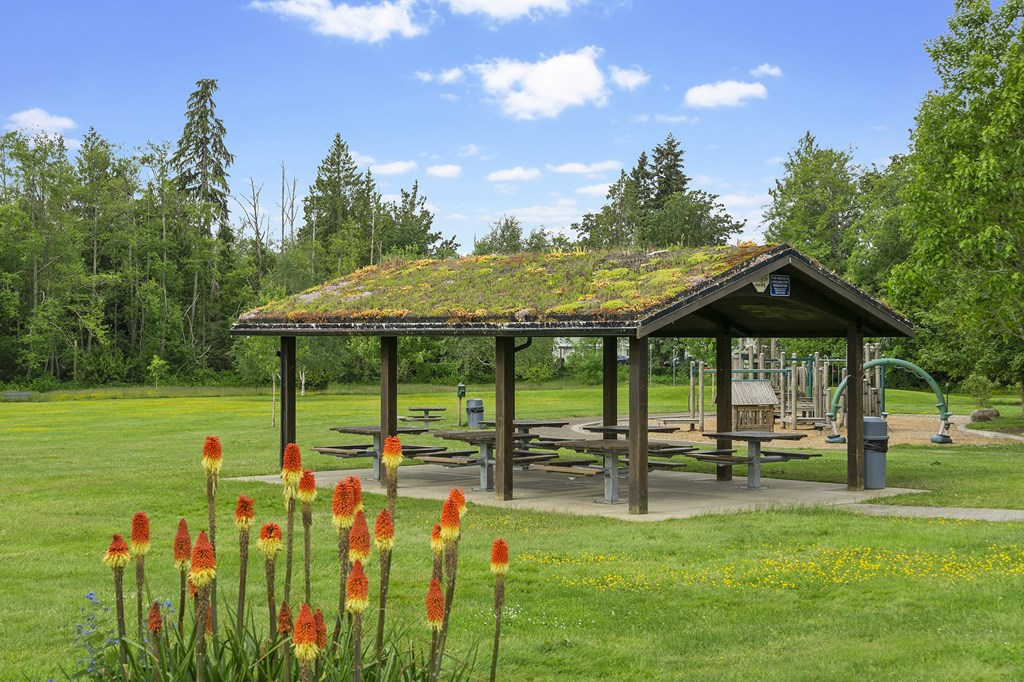 a pavilion with a picnic table in a park