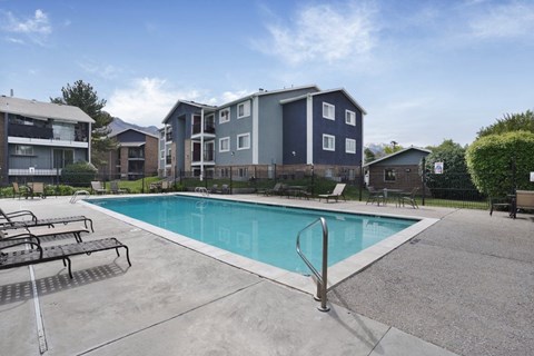A swimming pool in front of apartment buildings.