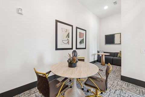 A modern dining room with a round table and chairs.