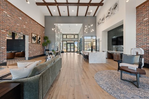 A modern living room with a long couch and a fireplace.