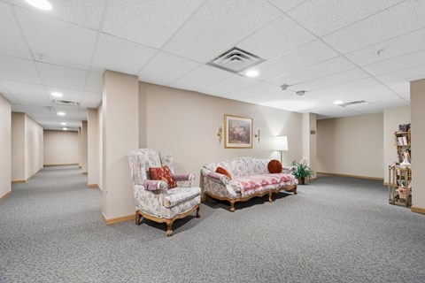 A living room with two chairs and a sofa.