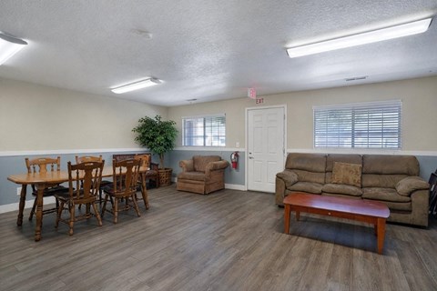 A living room with a dining table and chairs.