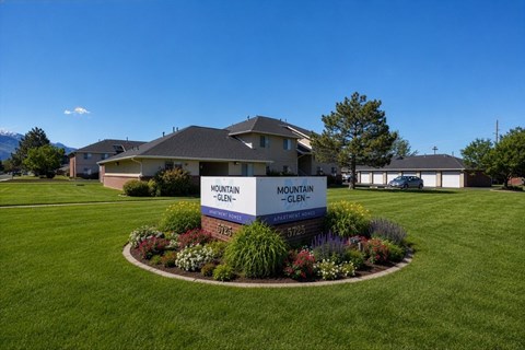 A sign in front of a building that says Mountain Glen.