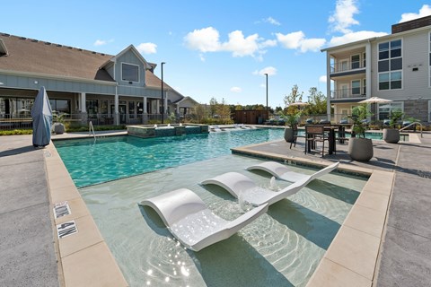 A modern pool with a white sculpture in the middle of it.