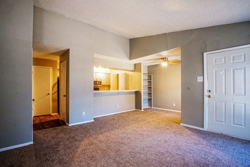 an empty living room with a white door
