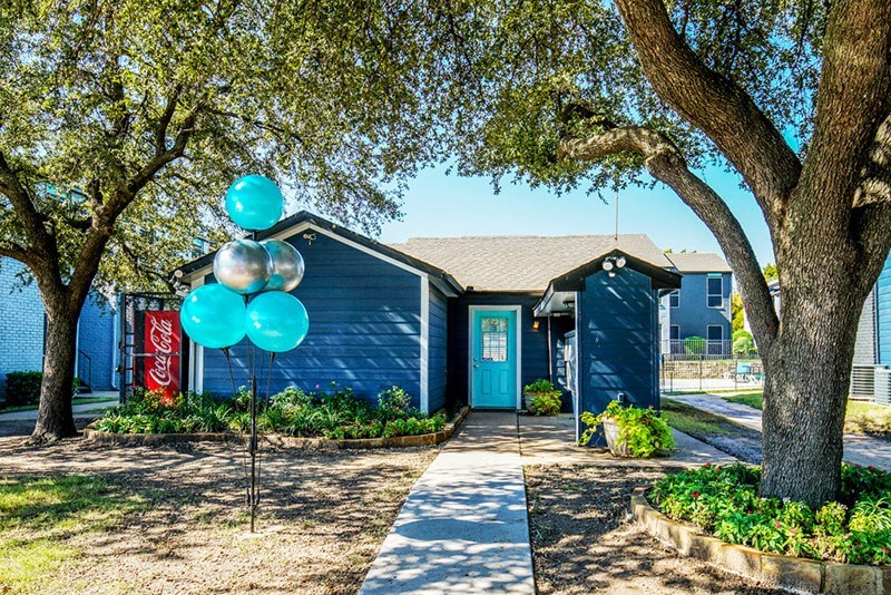 a blue house with blue balloons in front of it