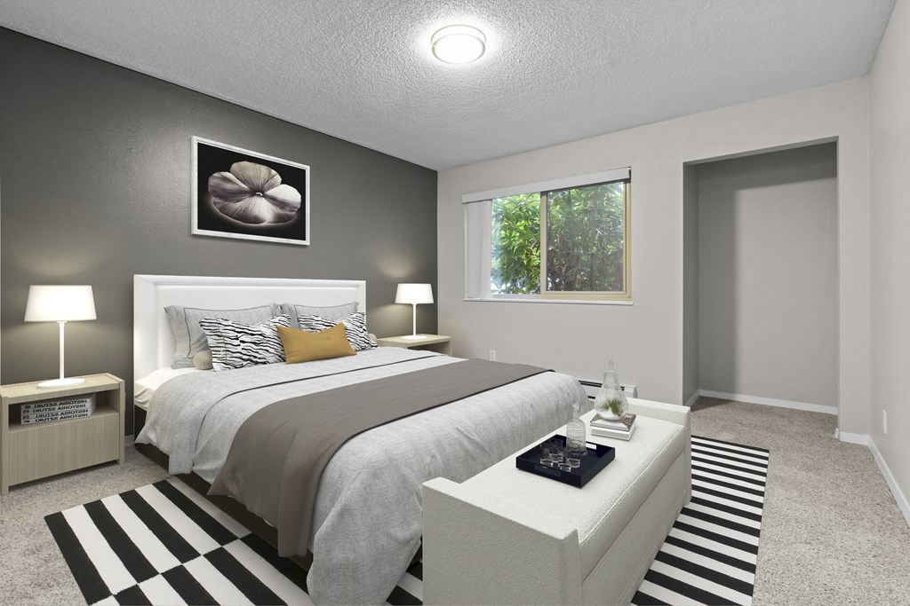 an image of a bedroom with a bed and a table