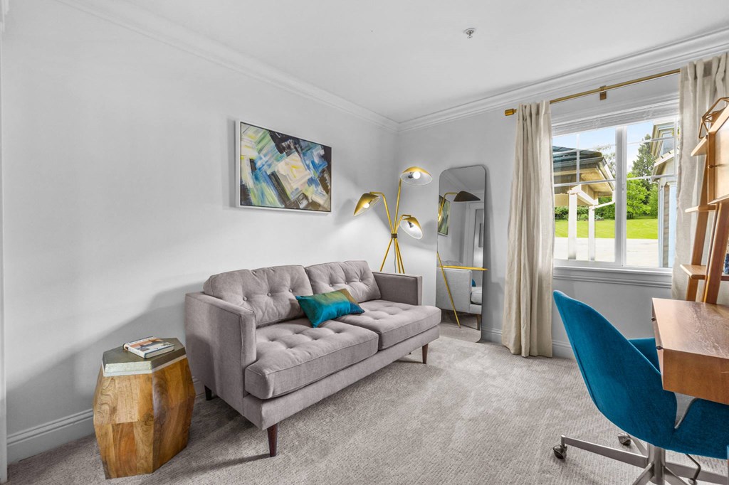 a living room filled with furniture and a large window