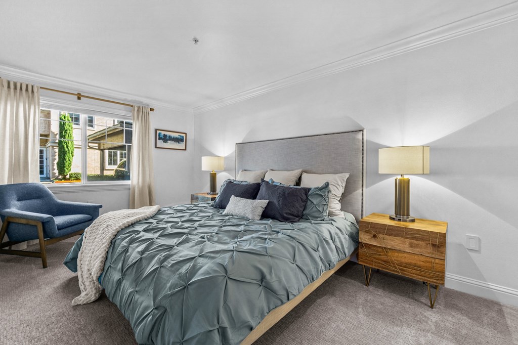 a bedroom with a large bed and a window