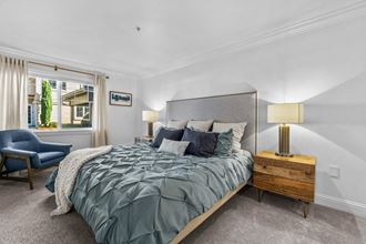 a bedroom with a large bed and a window - Photo Gallery