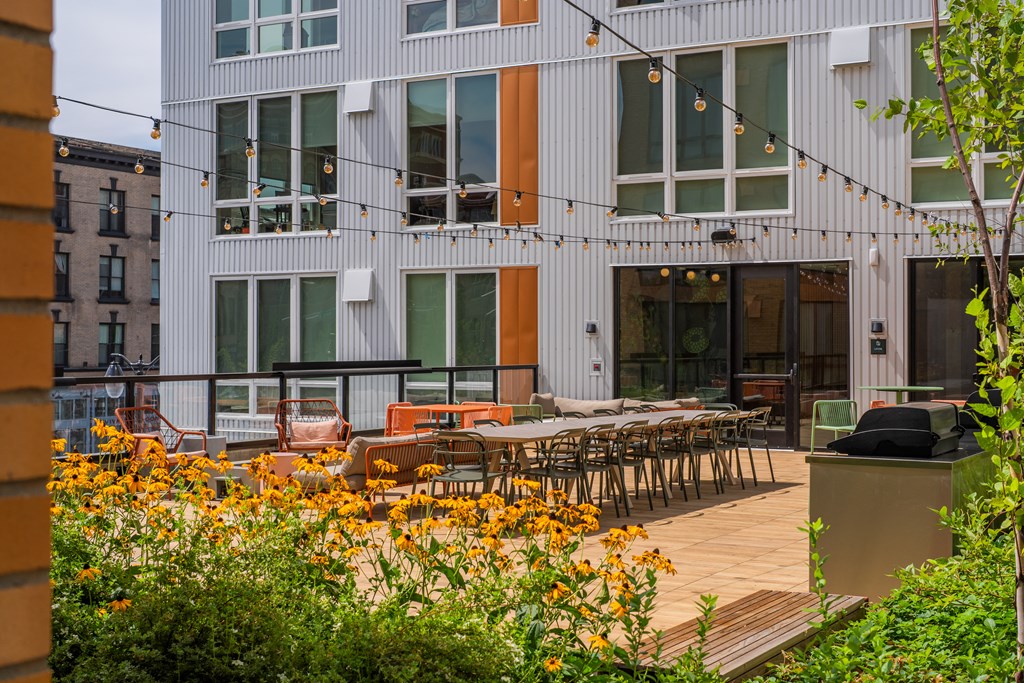 The Warren Apartments patio with dining and hanging lights