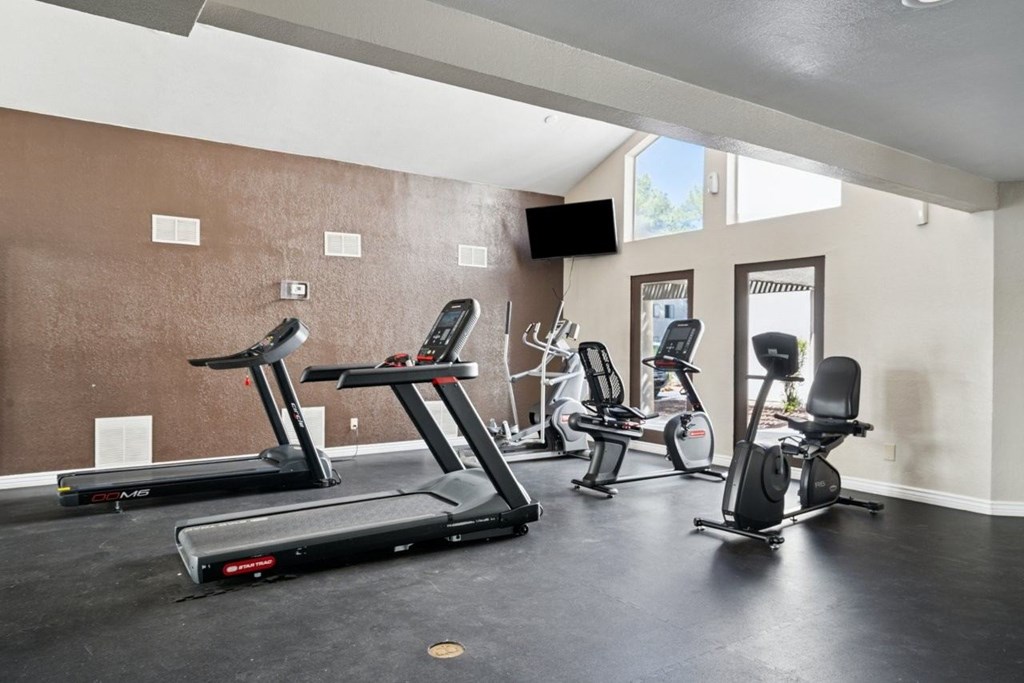 Casa Bella  A gym with treadmills, elliptical machines, and weights.