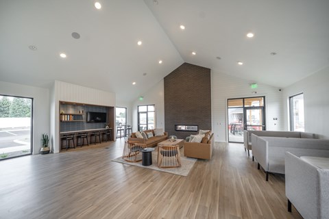 A spacious living room with a fireplace and a couch.