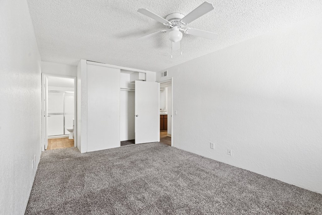 Casa Bella bedroom with carpet with door open to bathroom
