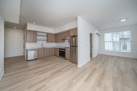 A kitchen with wooden floors and white walls.