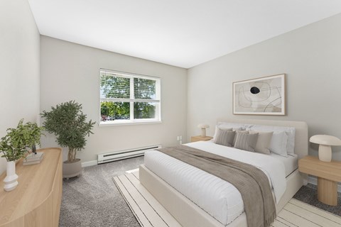 A bedroom with a large bed and a window.