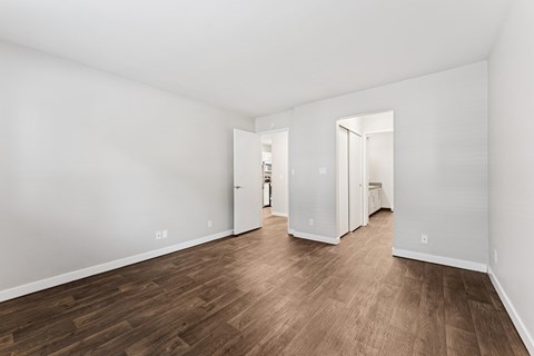 A room with wooden floors and white walls.