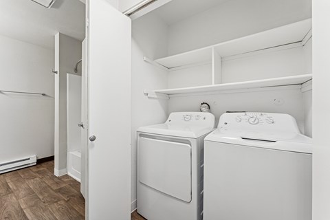 A small laundry room with a washer and dryer.