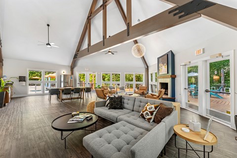 A living room with a grey couch and a black coffee table.