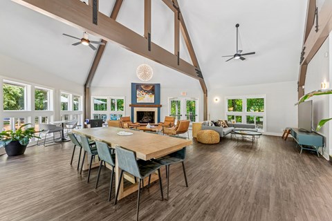 A dining room with a wooden table and chairs.