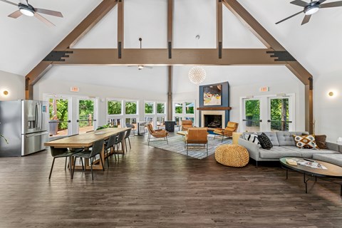A spacious living room with wooden floors and furniture.
