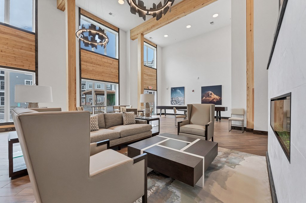 a living room with couches and chairs and a fireplace