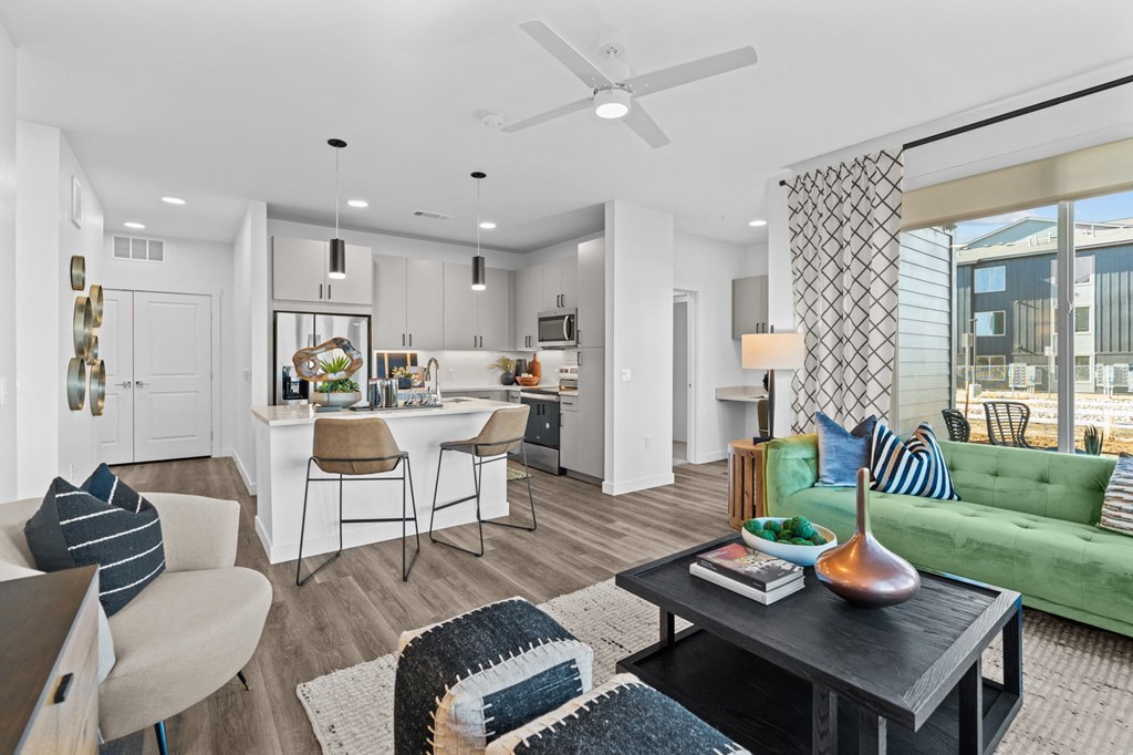 an open living room with a kitchen and a dining room