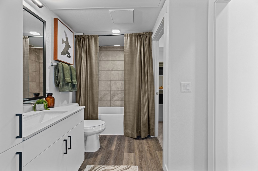 a bathroom with a shower and a toilet and a shower curtain