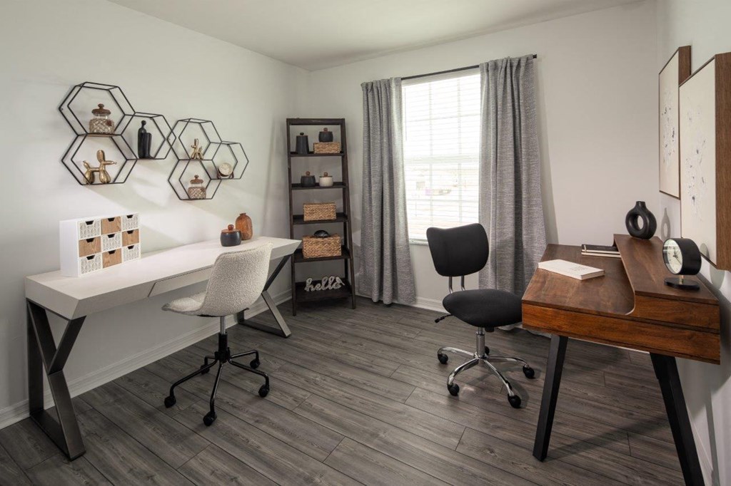 a home office with a desk and a window