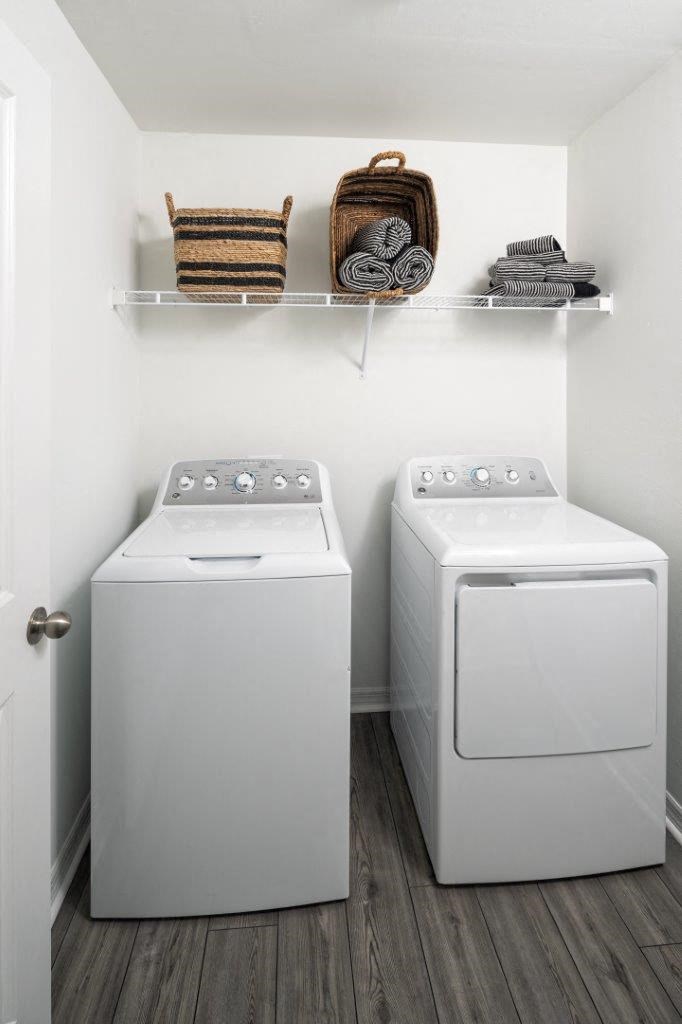 A small laundry room with a washer and dryer.