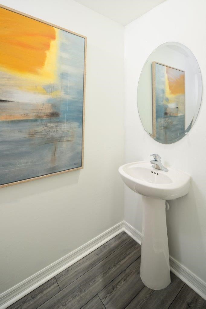 a white bathroom with a sink and a mirror