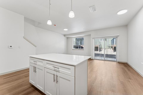 A kitchen with white cabinets and a countertop.