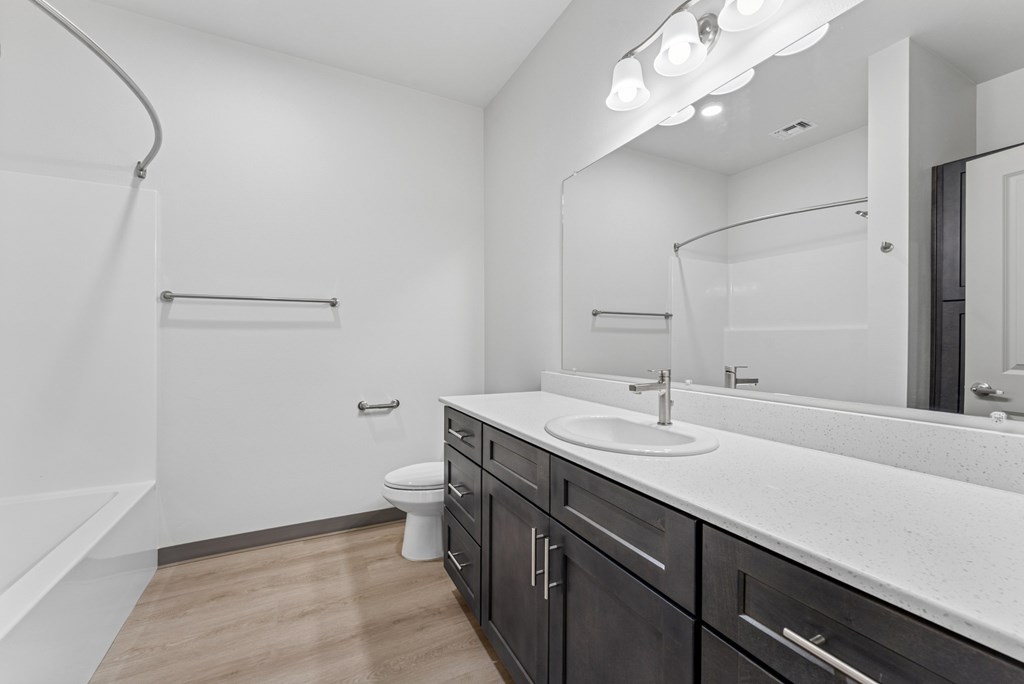 A bathroom with a white sink and a white toilet.