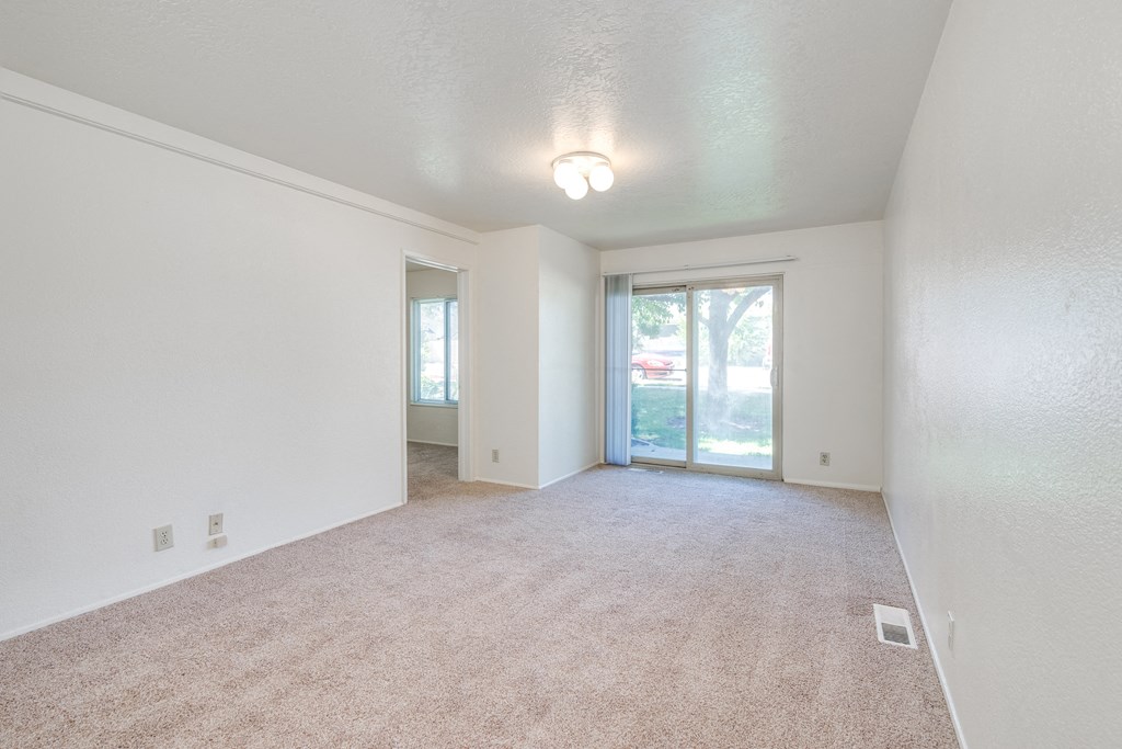 the living room and dining room of an empty house