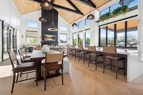 A modern dining room with wooden floors and furniture.