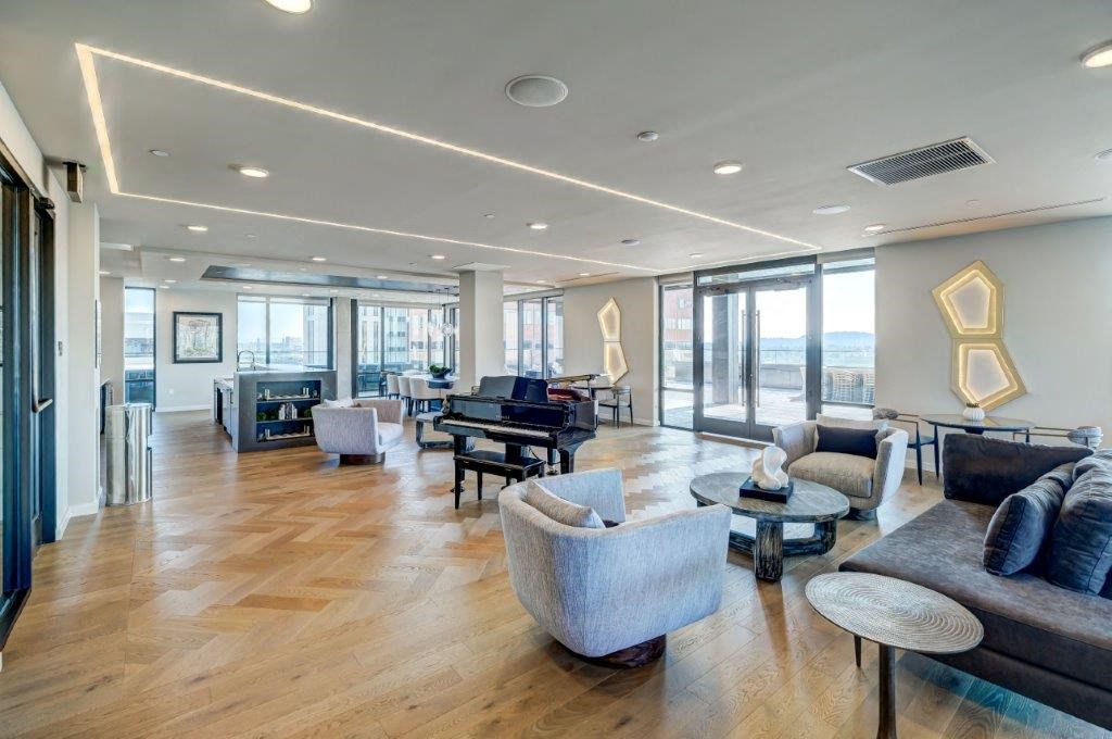 a large living room with furniture and a piano