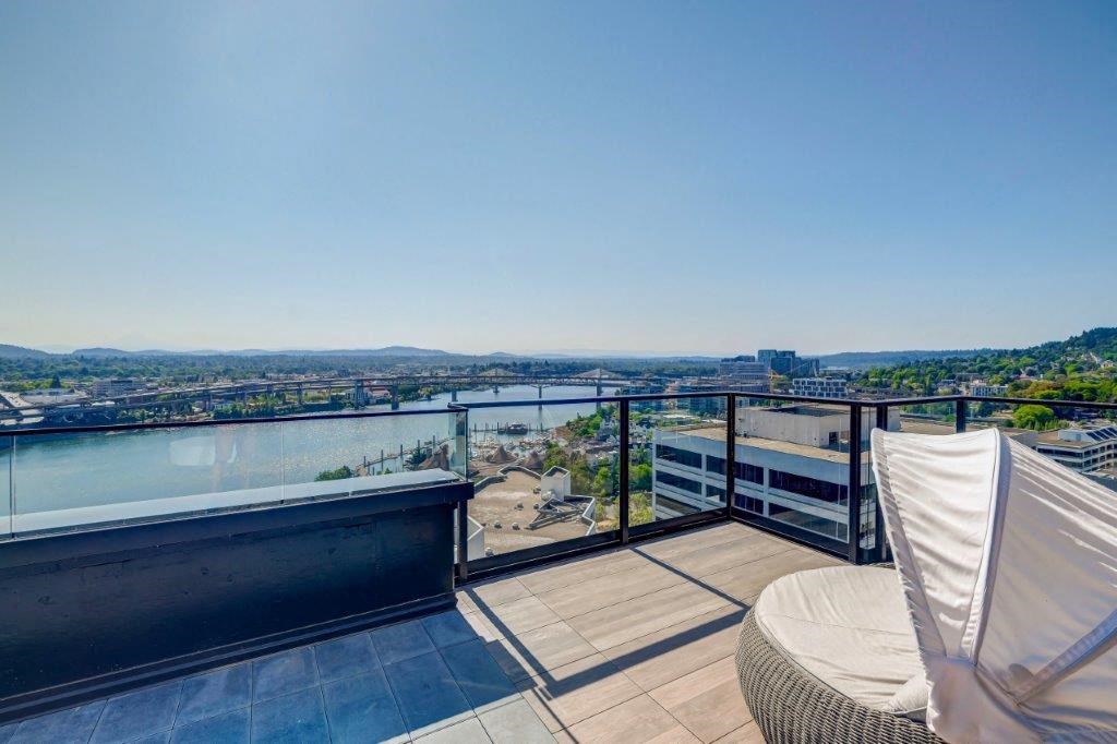a balcony with a view of a city and a river