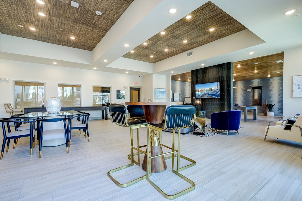 The Dylan resident clubhouse with tables and chairs and a flat screen tv