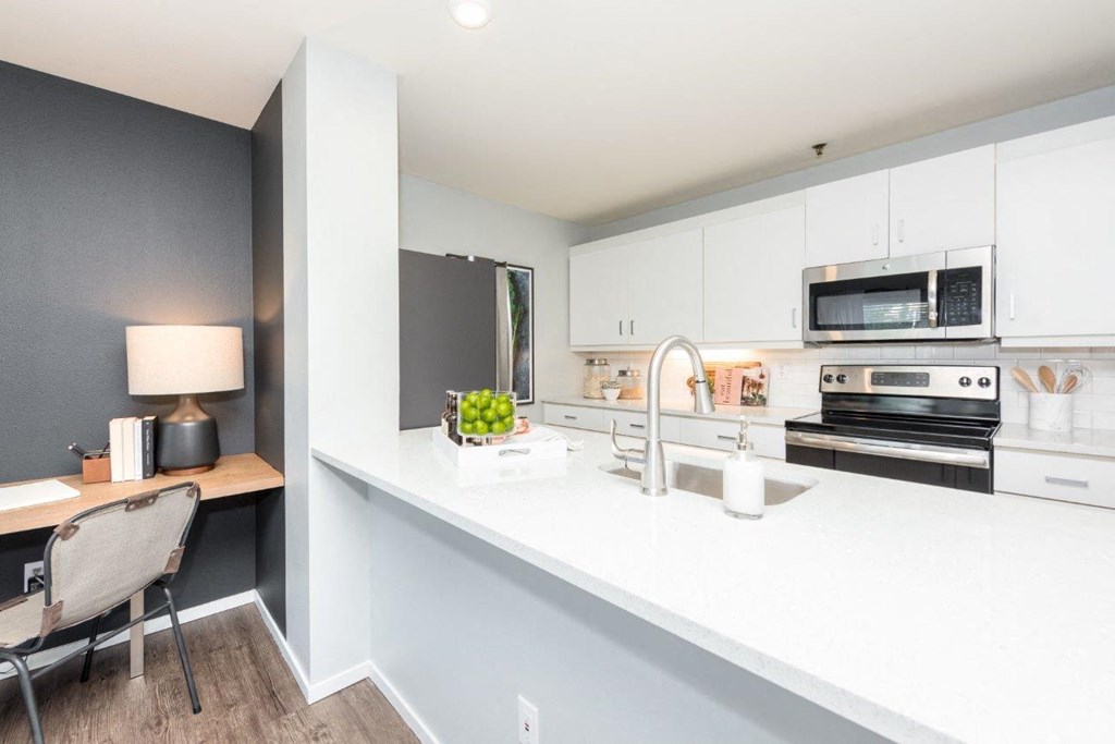 a kitchen with a large counter top and a sink